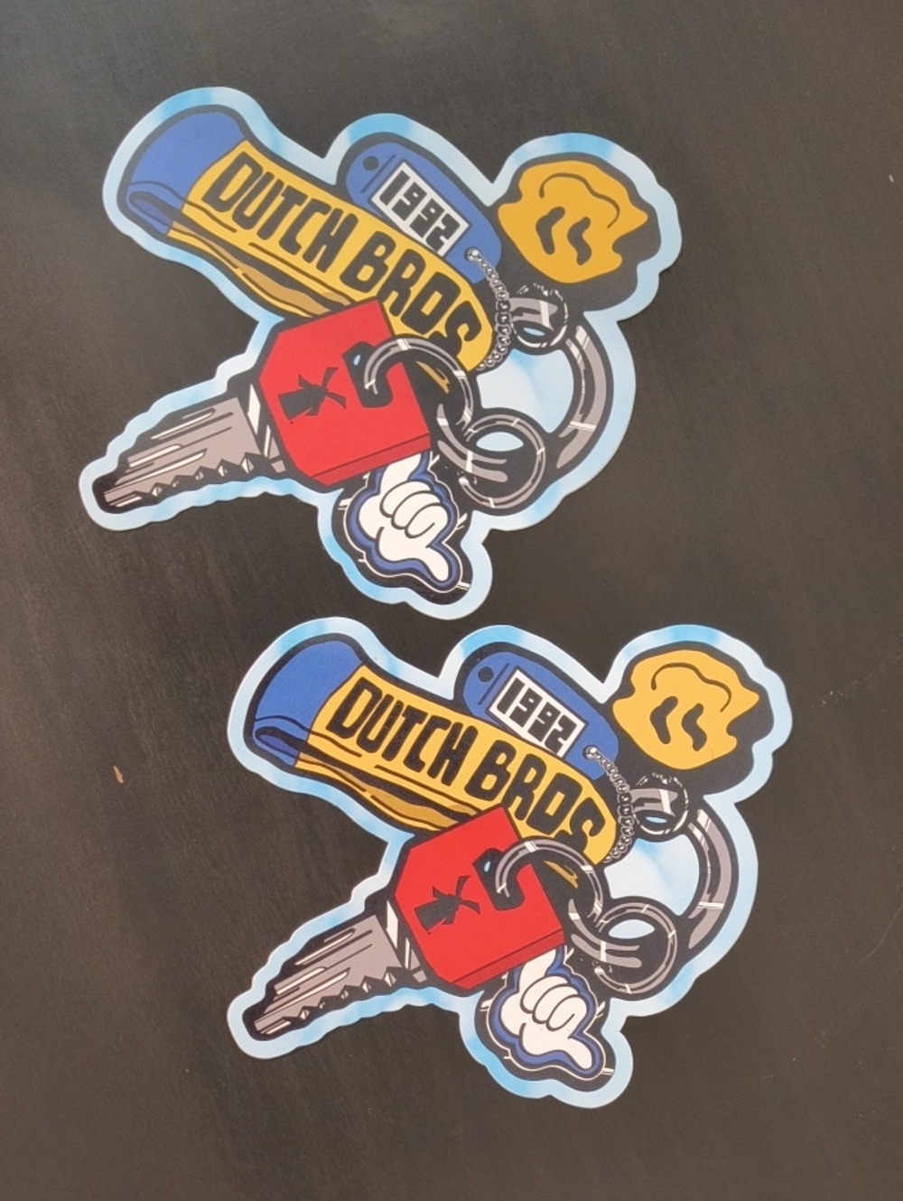 Dutch Bros Sticker with Yellow Banner, Blue Accents, and Red Key (2 Count)
